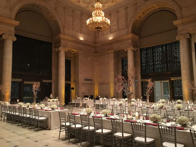 Tables and chairs set up for a reception inside the Asian Art Museum, San Francisco, CA.