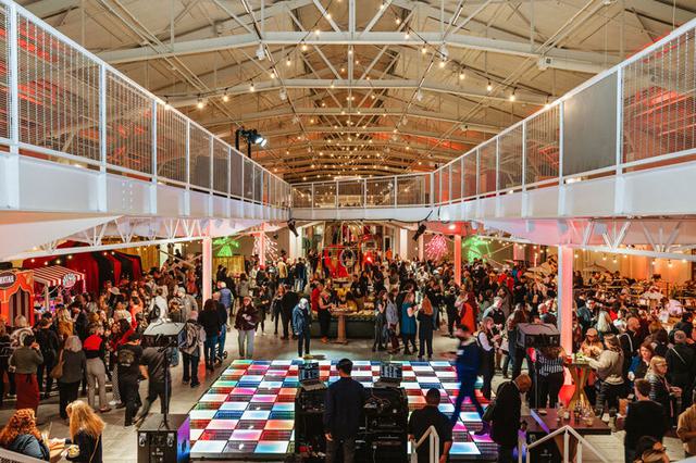 A crowd of people gathered at an event hall at Fort Mason, San Francisco.
