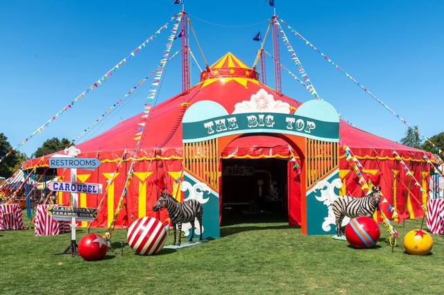 Enter the big top circus tent on a sunny day.