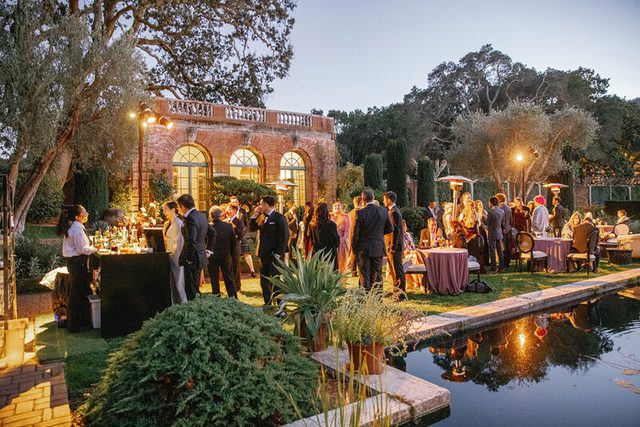 People gathered for an outdoor wedding ceremony at Filoli Historic House & Garden in Woodside, CA.
